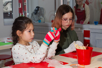 Two girls take part in a master class on making caramel.