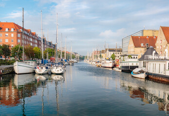 Fototapeta na wymiar reflection of boats on a canal in Copenhagen, Denmark
