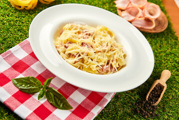 Pasta tagliatelli carbonara. Traditional italian dish of pasta with pancetta, ham, egg, hard parmesan cheese and cream sauce