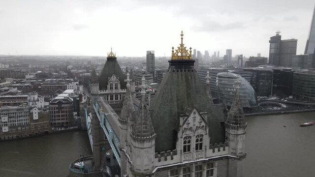 Stunning Aerial drone view of Tower Bridge, Thames River, United Kingdom, taken in a snow day UK 2021