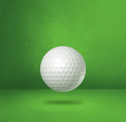 White golf ball on a green studio background