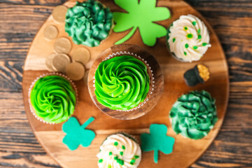 Tasty cupcakes for St. Patrick's Day on wooden background