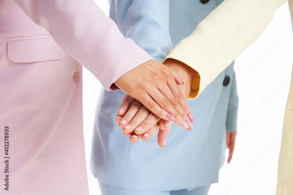 Poster Three women in pastel suits posing over white background