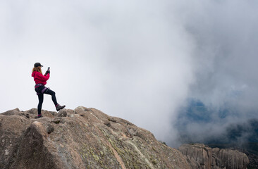 Naklejka na ściany i meble woman making a selfie on top of mountain