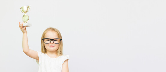 Cheerful little smart girl celebrating the win isolated over white background, wearing glasses...