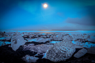 iceberg crystals at moonlight on a black sand beach