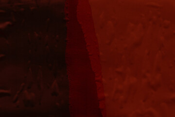 Red and brown torn paper collage close-up. Texture made from various paper and cardboard parts. Damaged old paper background. Vintage blank wallpaper. Material design backdrop.