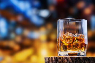 Scotch whiskey, whiskey glass stands on an oak whiskey stand against the backdrop of the city at...