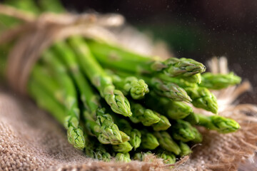 Fresh wild asparagus tied with rope in the kitchen, selective focus