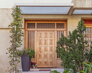 Fototapeta na wymiar contemporary house entrance natural wood door, Athens Greece