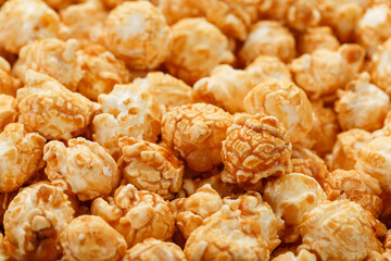 Popcorn in caramel glaze close-up as a background.