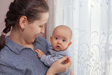 Happy mom holding baby in her arms