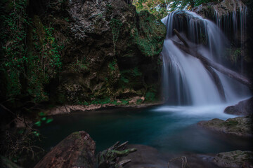 Waterfall in the forest. Carpathian Mountains. Clean water. Mossy rocks. La Vaioaga, Banat, Romania.