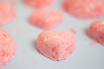 selective focus of a bath bomb from sea salt, citric acid, soda, dye and flavor on a blue background