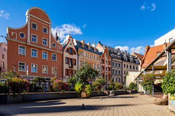 Beautiful sunny summer day in empty medieval city of Riga where colorful old houses are lined up on...