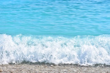 Beautiful blue lagoon with turquoise sea and wet pebble stones, with selective focus. Turquoise clean water background with natural stones. Fethie, Turkey 