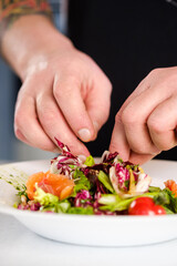 The chef makes a ready-made salad dish.