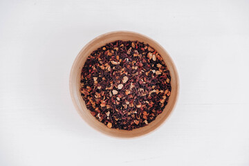 Dry fruit tea in a wooden plate on a white background. Top view. Copy, empty space for text