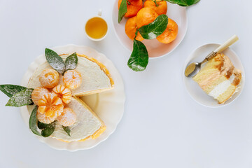 Piece of mandarin sponge cake decorated with fresh tangerines.
