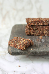Raw energy bars with nuts and seeds on bright background