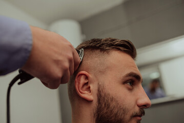 Obraz premium Young Man in Barbershop Hair Care Service ConceptYoung Man in Barbershop Hair Care Service Concept