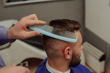 Fototapeta premium Young Man in Barbershop Hair Care Service ConceptYoung Man in Barbershop Hair Care Service Concept