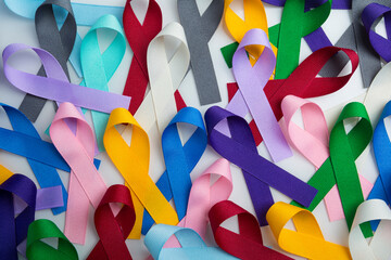 Multi colored cancer ribbon background. Proudly worn by patients, supporters and survivors for...