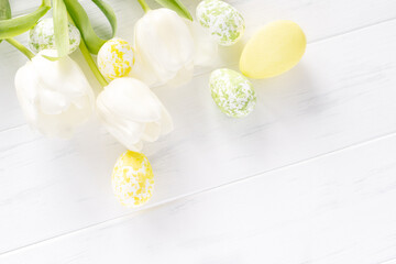 Color egg easter and white tulips flowers on white background with copy space. Banner, flatly