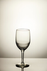 Empty wine glass with reflection isolated on white background.