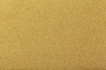 Sparkle glowing gold glitter of carborundum abstract textured background