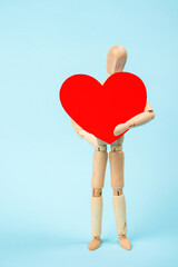 Mannequin man holding a red heart. Love symbol. Happy Valentine's Day Greeting Card, Mother's Day,...