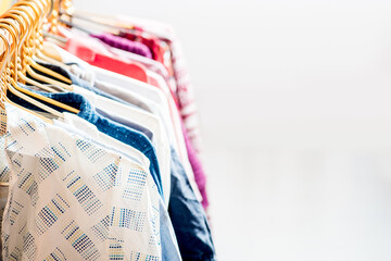 Lot of different clothes on hangers. Copy space