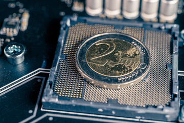 2 euro coin over a CPU slot in a motherboard, symbolizing the Digital Euro. European and the...