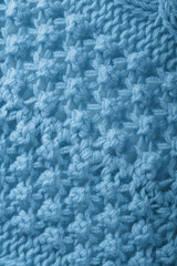 Blue knitted handmade warm textured background close-up