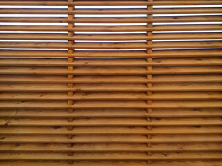 Corrugated wooden fence background with horizontal slats. Texture of wooden boards with holes ideal for placing text and creating designs.