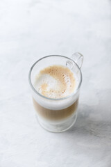 Coffee with milk on bright wooden background. Close up. Copy space.