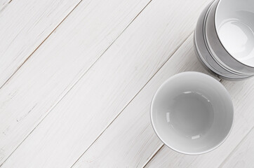 White round deep porcelain soup plates stand on a white table