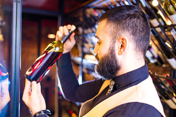 arabian man sommelier appreciating drink in lux hotel