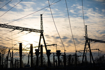 High-power electricity transmission station at sunset with an installed lightning protection system.
