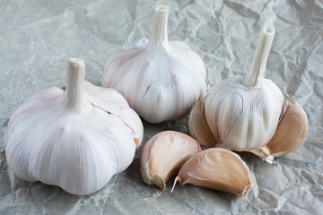 unpeeled ripe garlic on crumpled paper
