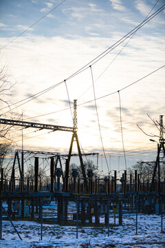 High-power electricity transmission station at sunset with an installed lightning protection system.