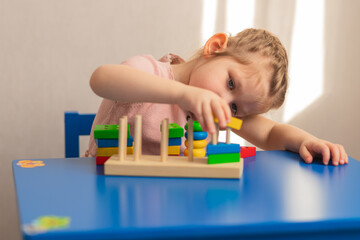 
Children's wooden toy. The child collects the sorter. Educational logic toys for children....