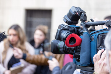 Filming media event or news conference with a video camera. Public relations - PR concept.