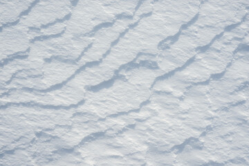 Fresh clean white snow background texture. Winter background with frozen snowflakes and snow mounds. Snow lumps. Seasonal landscape details. Cold weather.