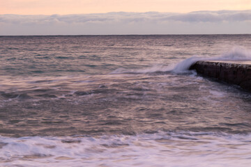 beautiful sea with waves, foam at sunset on the background of the sky with clouds on a good evening in travel, walking, vacation, tourism, travel, holiday