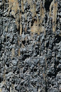 Detail of carved and blasted volcanic basalt rock for road access, Oregon