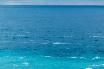 beautiful, blue sea with waves, foam on a nice, warm day in the tropics travel, vacation, walk