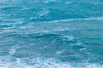 beautiful, blue sea with waves, foam on a nice, warm day in the tropics travel, vacation, walk