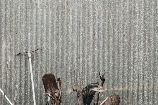random old tools against a tin shed wall