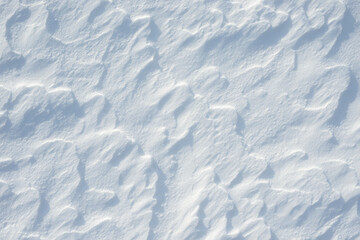 Fresh clean white snow background texture. Winter background with snowflakes and snow mounds. Snow lumps. Seasonal landscape details.